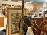 a cross on a table with a picture and a teddy bear