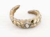 un gros plan sur un bracelet en argent orné d'un motif floral