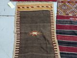 three different types of rugs on a table with tags on them
