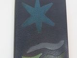 a black wallet with a blue star on top of it