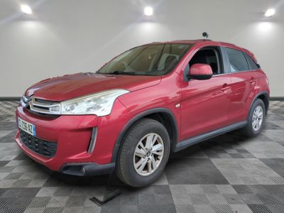 the red suv is parked in the garage on a checkered floor