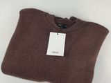 a brown sweater sitting on top of a white table