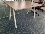 tables and chairs in an office setting with blue and white carpet