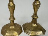 pair of antique brass candlesticks on a white background