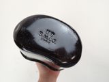a hand holding a black object with the word us smec on it