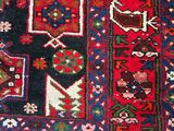 an image of a red and blue rug with many different designs on it