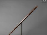 an old baseball bat sitting on top of a metal stand