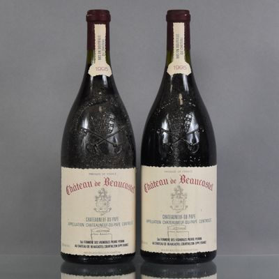two bottles of wine sitting on top of a table next to each other