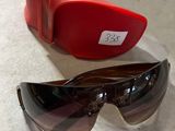 une paire de lunettes de soleil et un étui rouge posés sur une table