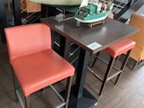 a table with two chairs and a model of a sailboat on top of it