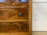 an image of a wooden chest of drawers in a room