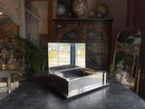 a mirror on top of a black table in a room