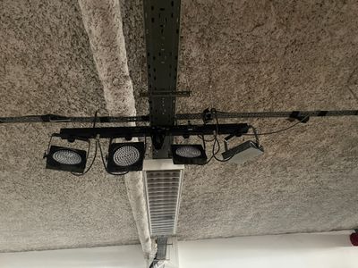 four lights hanging from the ceiling of a building