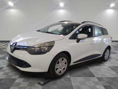 the white car is parked on a checkered tile floor