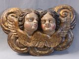 two angels that are sitting on top of each other