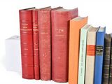 books are lined up in a row on a white surface