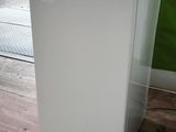 a white refrigerator sitting in the corner of a room