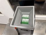 a container that has a bunch of green and white items in it
