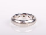 a close up of a silver ring on a white surface