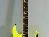 an electric guitar with a yellow body and a black neck