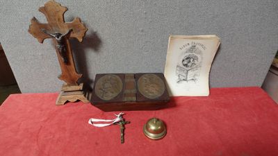 an old wooden box with a cross, a book, and a key