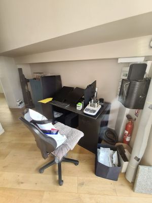 a desk with a chair and a computer on it