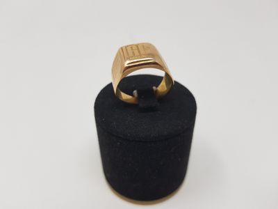 a close up of a gold ring on a black ring holder