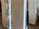 two mattresses stacked on top of each other in a warehouse