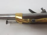 an old gun with a wooden handle and a brass handle