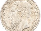 a close up of a coin with a man ' s face on it