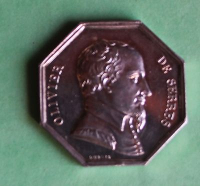 a silver coin with a picture of a man on it
