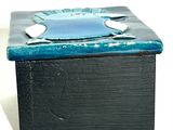 a black box with a blue flower on it