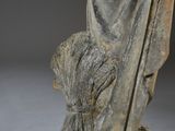an old statue of a woman holding a flower in her hands