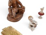 a small figurine of a boy sitting on a chair