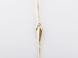 a close up of a gold plated necklace on a white background