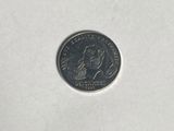 a close up of a small coin on a white surface