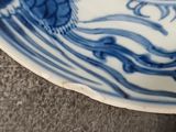 a blue and white plate with a flower design on it