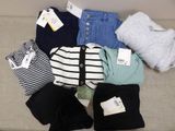 a pile of clothing that is sitting on a couch