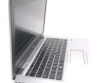 a white laptop with a black keyboard on a white surface