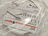 a package of scissors and a pair of scissors on a table