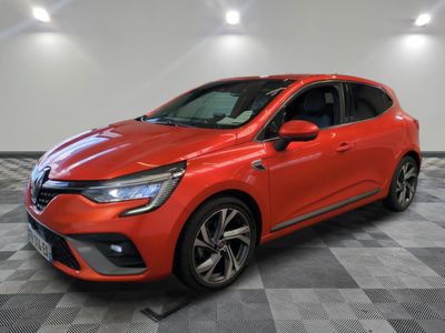 a red car parked in a garage with a checkered floor