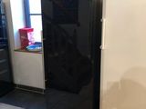 an image of a kitchen with a refrigerator and a window