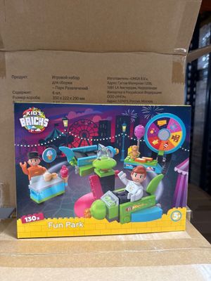les jouets se trouvent dans une boîte en carton posée sur une table, devant une autre boîte en carton