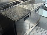 a kitchen with a sink and a counter with two sinks