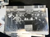 many old photos of men sitting around a table