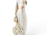 figurine of a woman with a dog on a white background