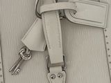a white purse with a bunch of keys attached to it