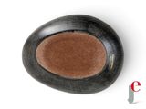 a black vase with a brown interior on a white surface