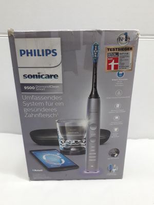 emballage d'une brosse à dents électrique Philips Sonicare accompagné d'un verre d'eau