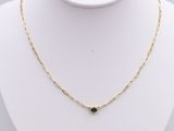 a gold chain necklace with a green stone on it